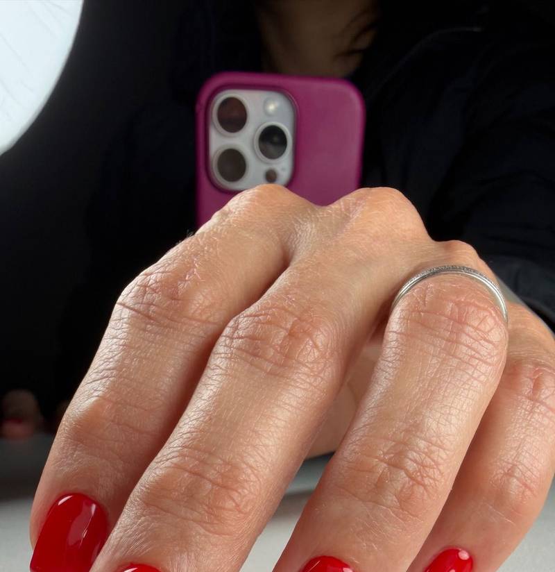 Short square nails in a classic glossy red — by Alice Garrido